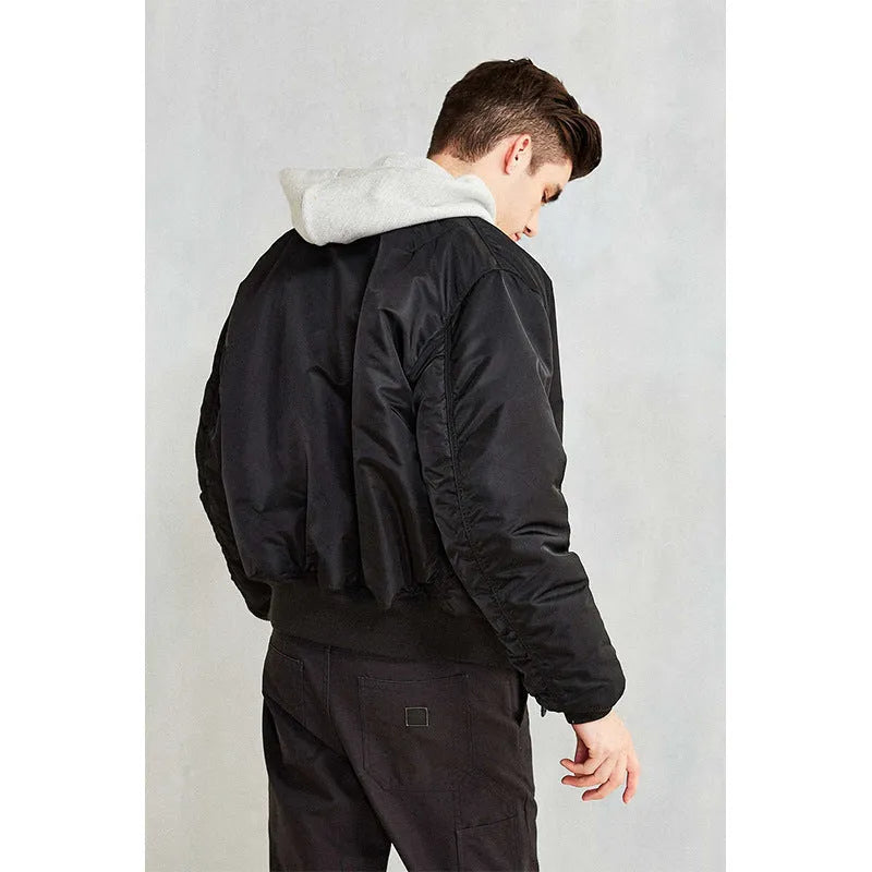 Men's loose-fit Army Green cotton-padded pilot jacket with wear-resistant nylon fabric on a hanger.