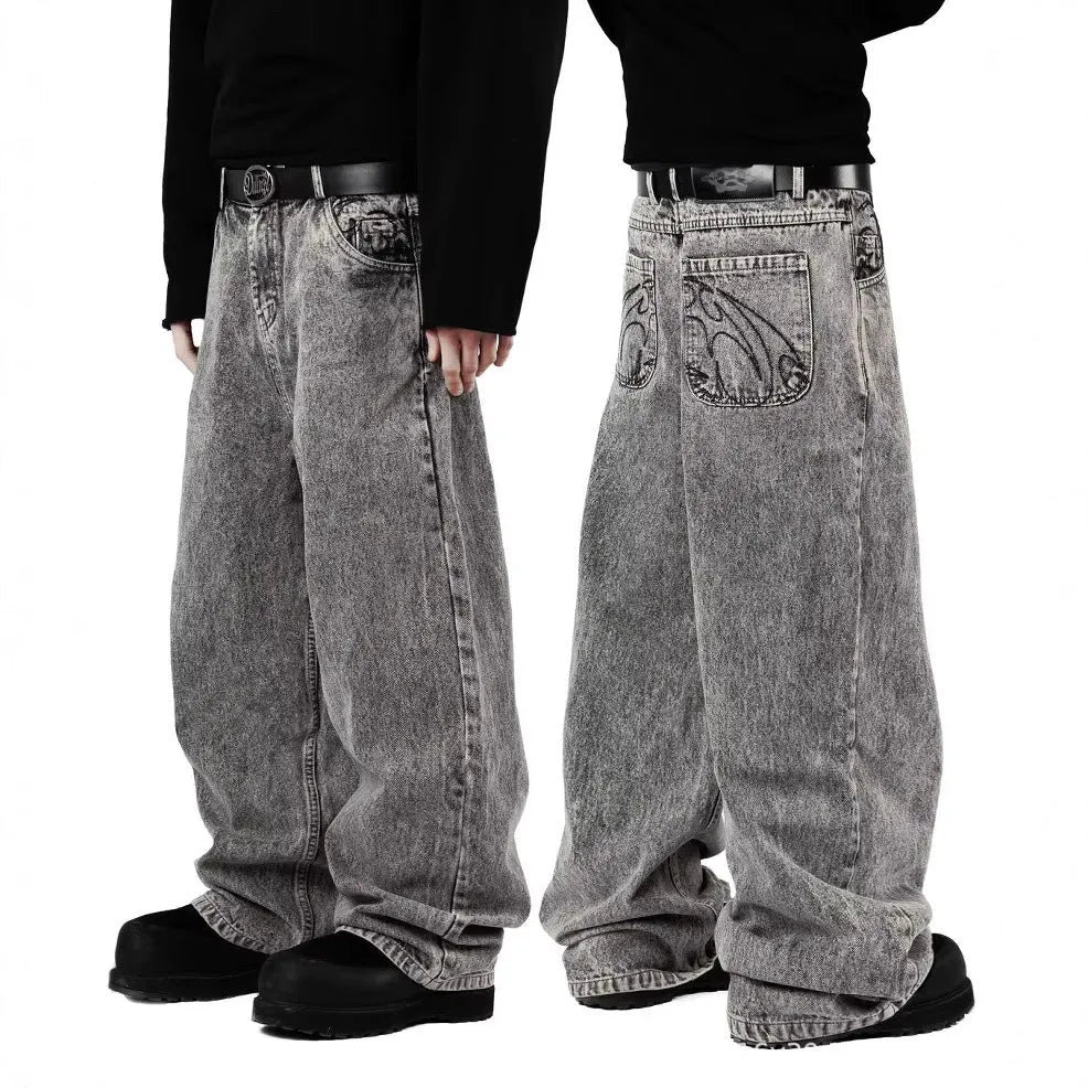 Grey loose straight-leg denim trousers on hanger showing mid-waist design and cotton fabric texture