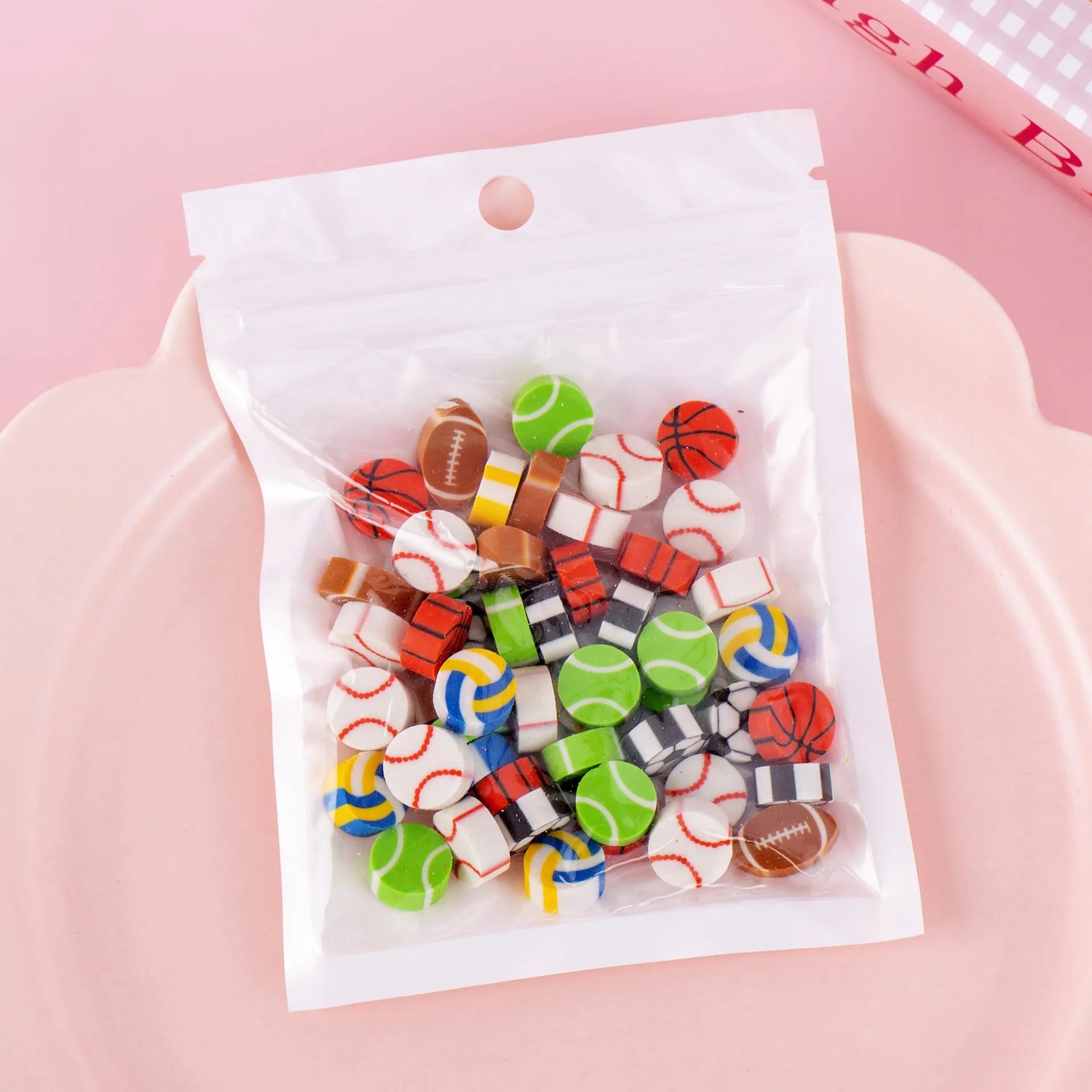 Assortment of fifty small cartoon-shaped rubber erasers in fruit and animal designs.