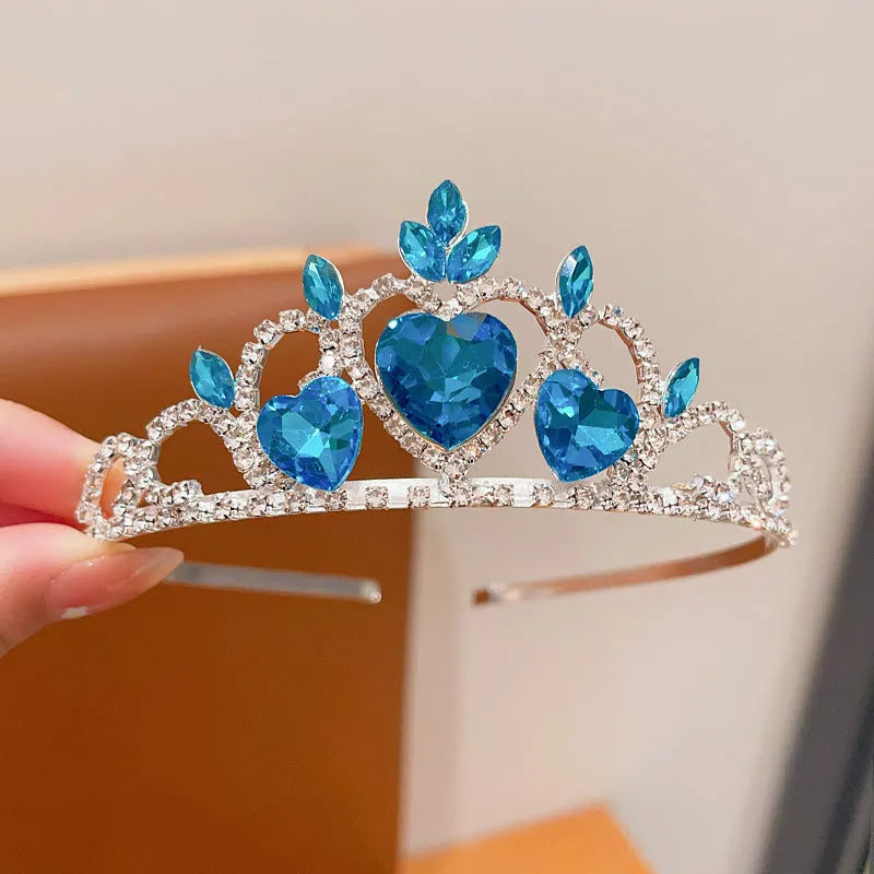 Children's electroplated alloy crown headband with pink crystals, shown on a model for scale.
