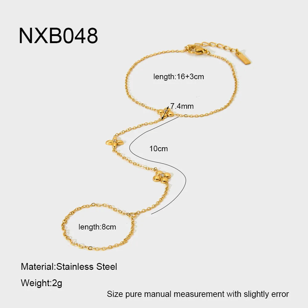 Gold stainless steel women's bracelet with geometric design showing floral patterns and eight-pointed star charms