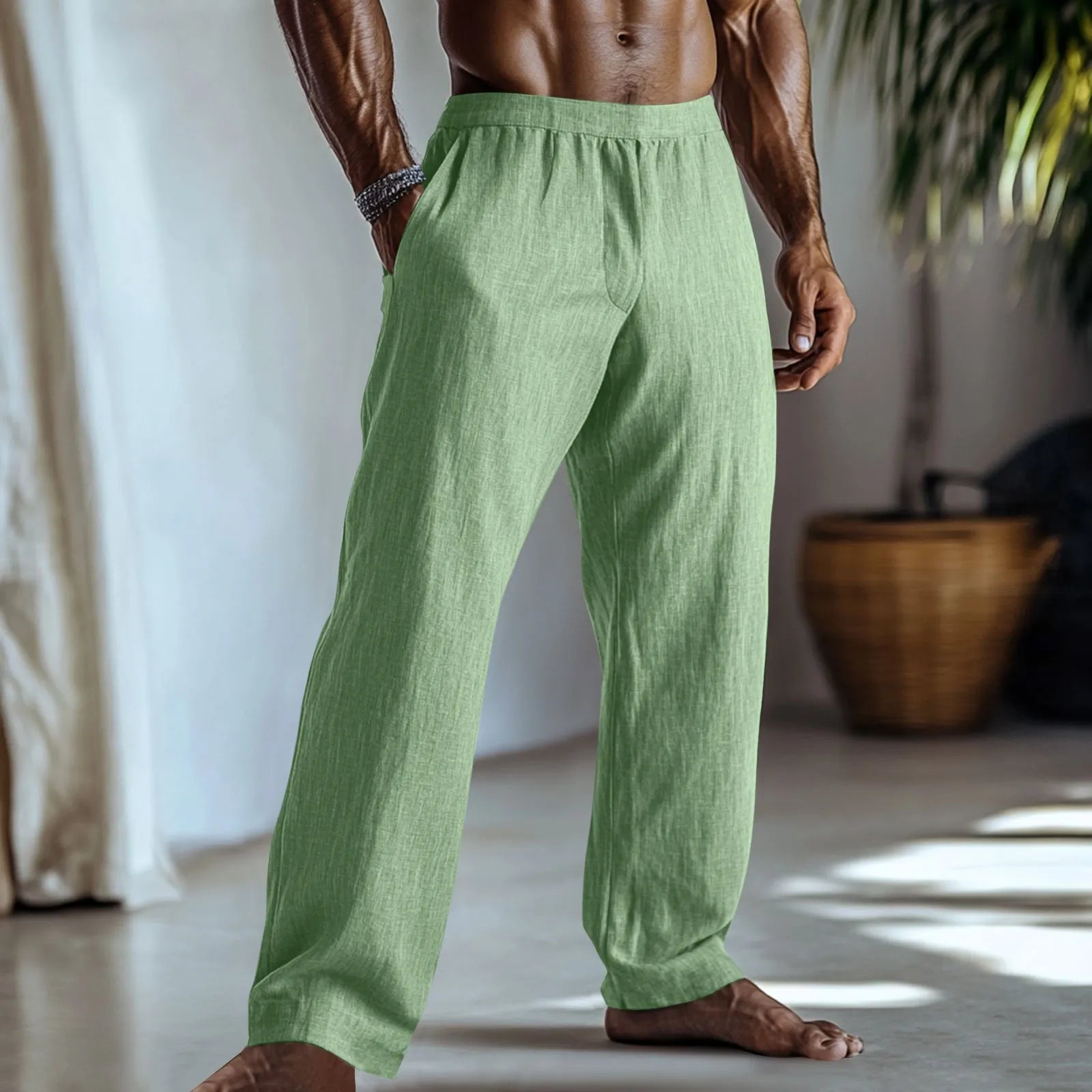 Straight-leg casual trousers in cotton and linen fabric on a hanger, showing light green colour and pocket detail