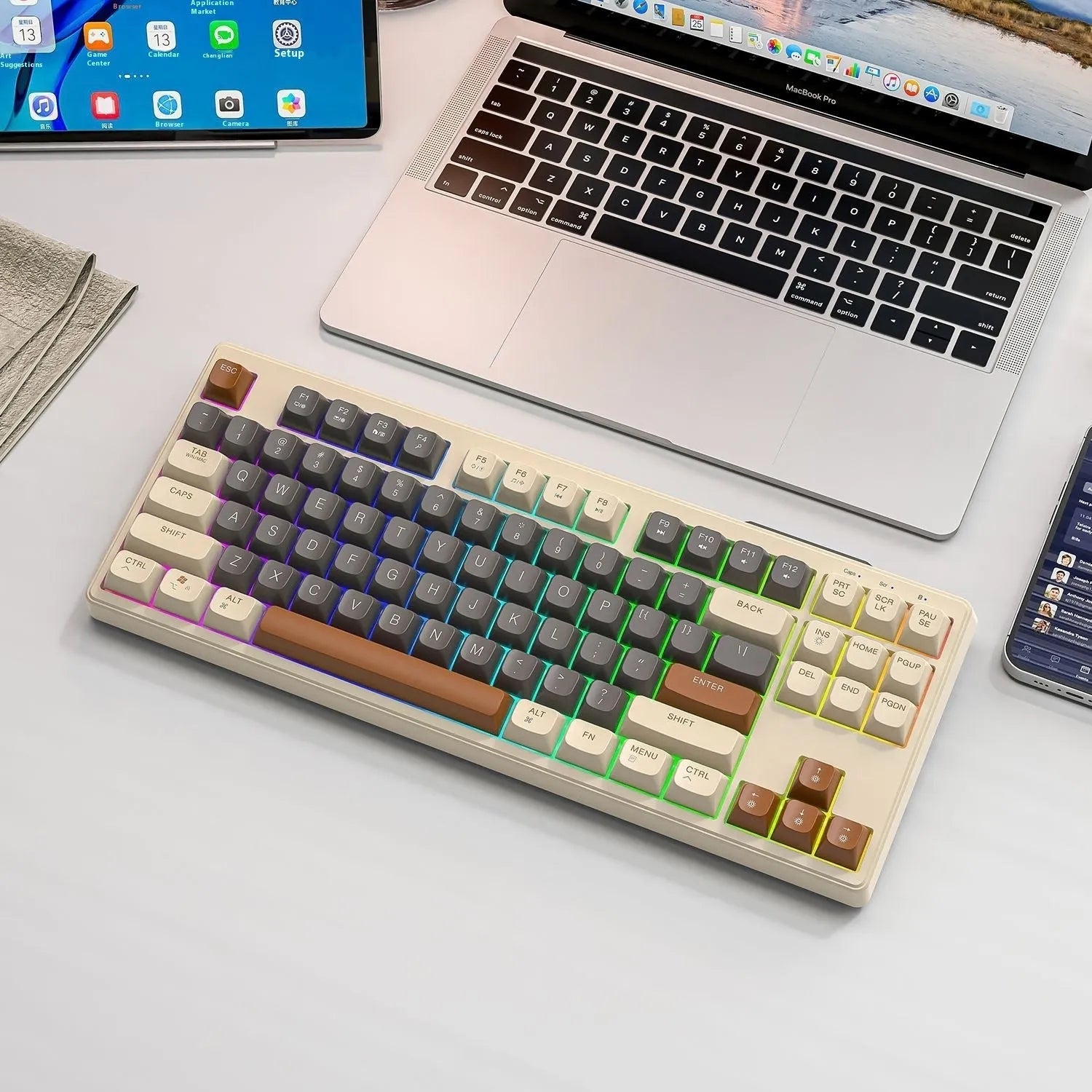 Free Wolf M87 wireless dual-mode keyboard in blueberry colour on a desk with USB receiver and cable.