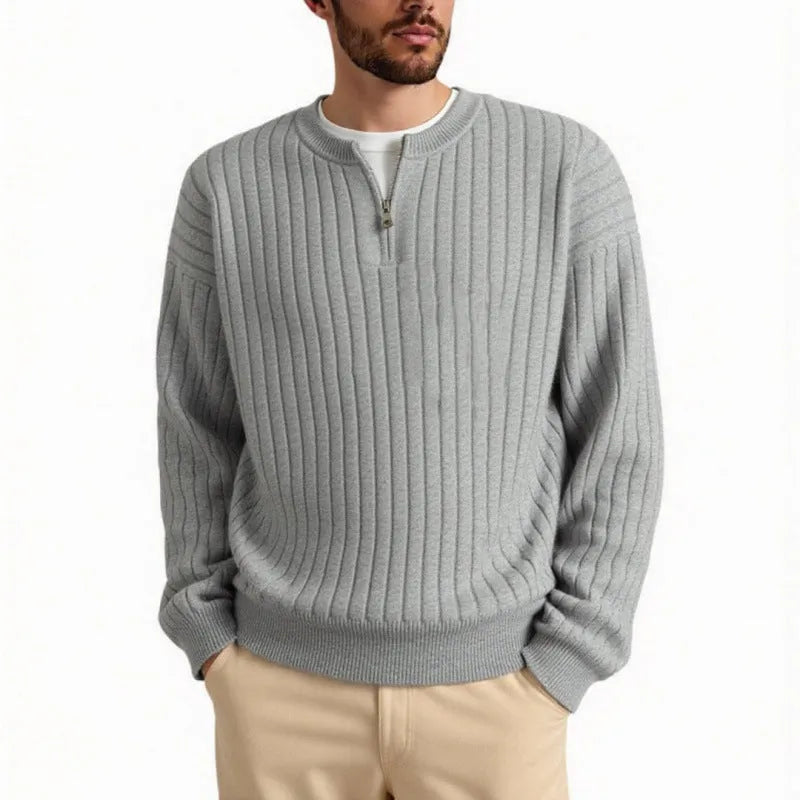 Grey half-zip loose knit sweater for men with long sleeves on a hanger.