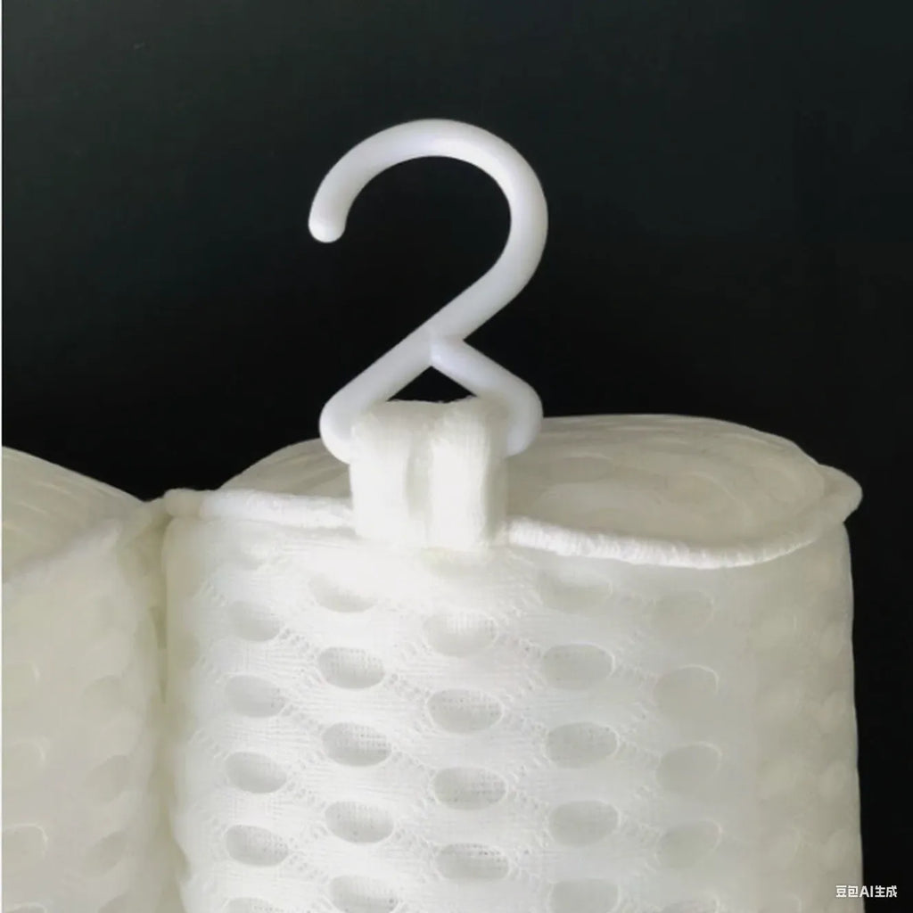 White bathtub pillow with mesh fabric and suction cups on a bath mat.