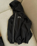 Grey loose fit men's hooded sunscreen jacket hanging, showing front design and hood.