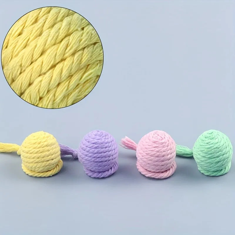 Cat toy ball with attached rope and bell in green, pink, purple or yellow colours showing 6cm and 3cm size comparison