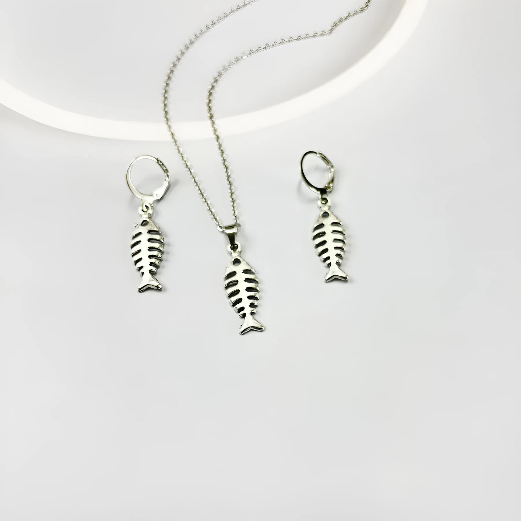 Retro fishbone design alloy necklace and matching earrings set on a dark background.