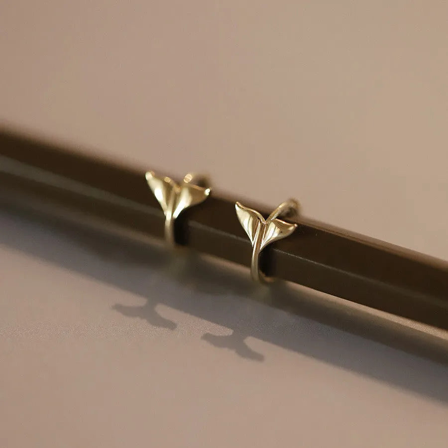 Gold plated sterling silver fishtail earrings with smooth finish and 8-10mm diameter.