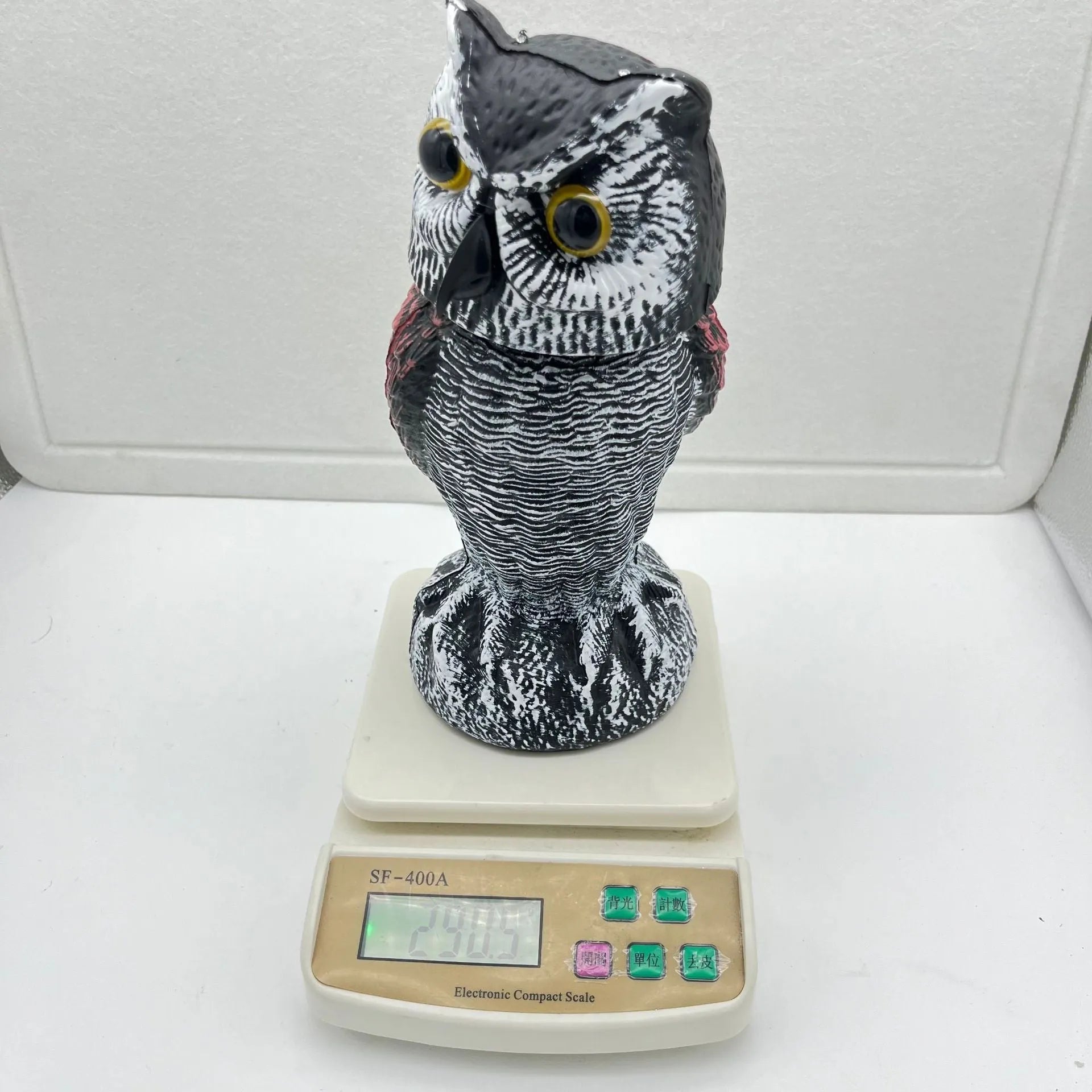 PE plastic artificial owl bird scarer ornament with shaking head, shown in bag-style mounting option.