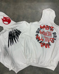 Black loose hooded sweatshirt with white skull print and rhinestone details, worn open as a cardigan.