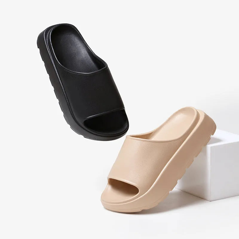 Women's beige fish mouth slippers with a thick 5.5cm EVA platform sole on a wooden floor.