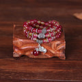 Handmade natural watermelon crystal bracelet with Chinese knots, shown in geometric national style.