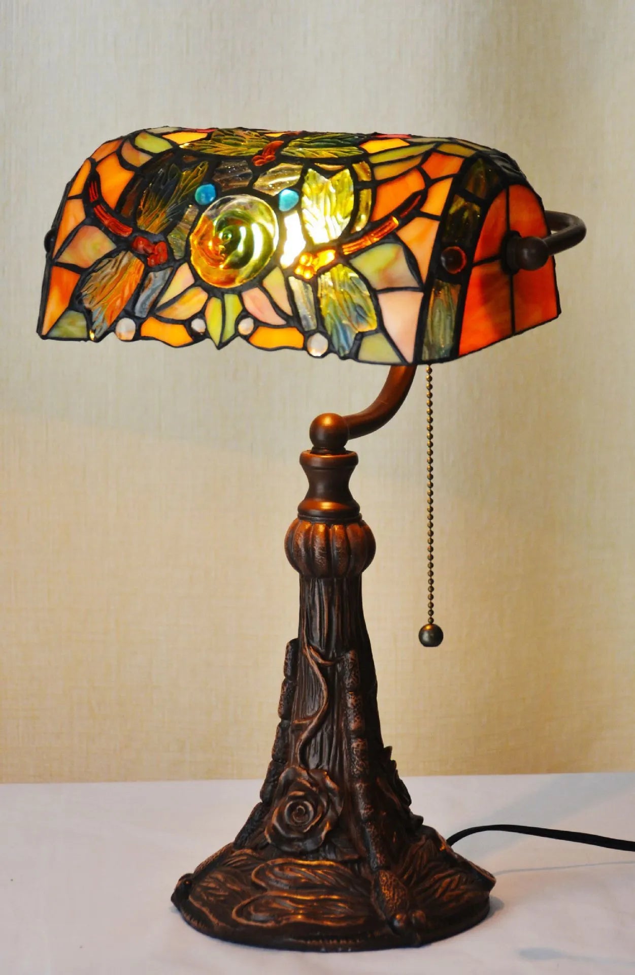 Tiffany table lamp with coloured glass shade on resin base, 36cm tall