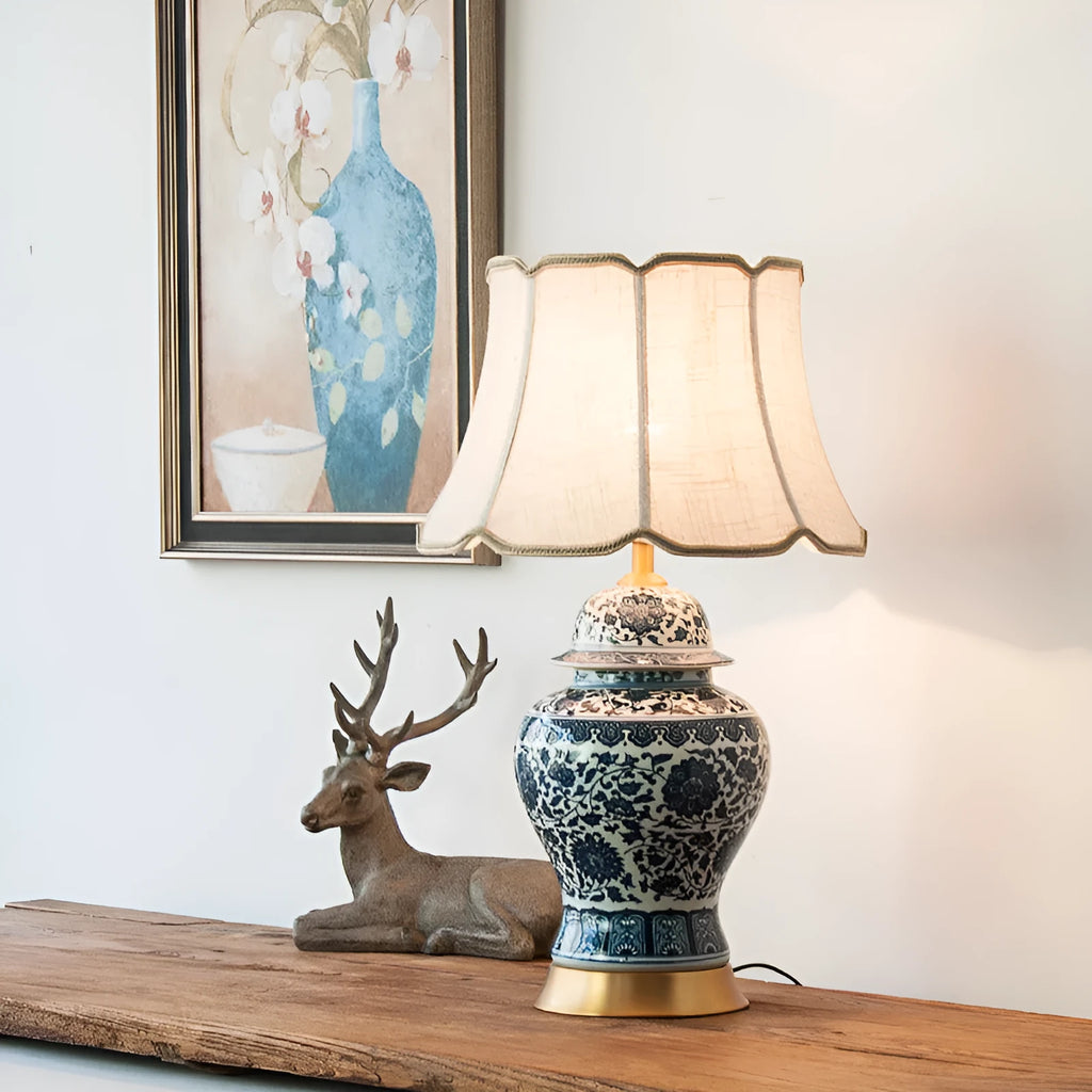 Chinese blue and white porcelain table lamp with cloth shade on wooden surface