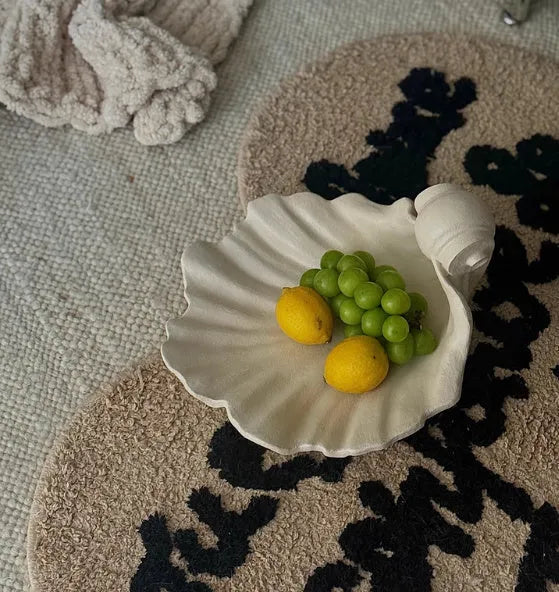 White resin shell-shaped ornament for fruit plate decoration on a table