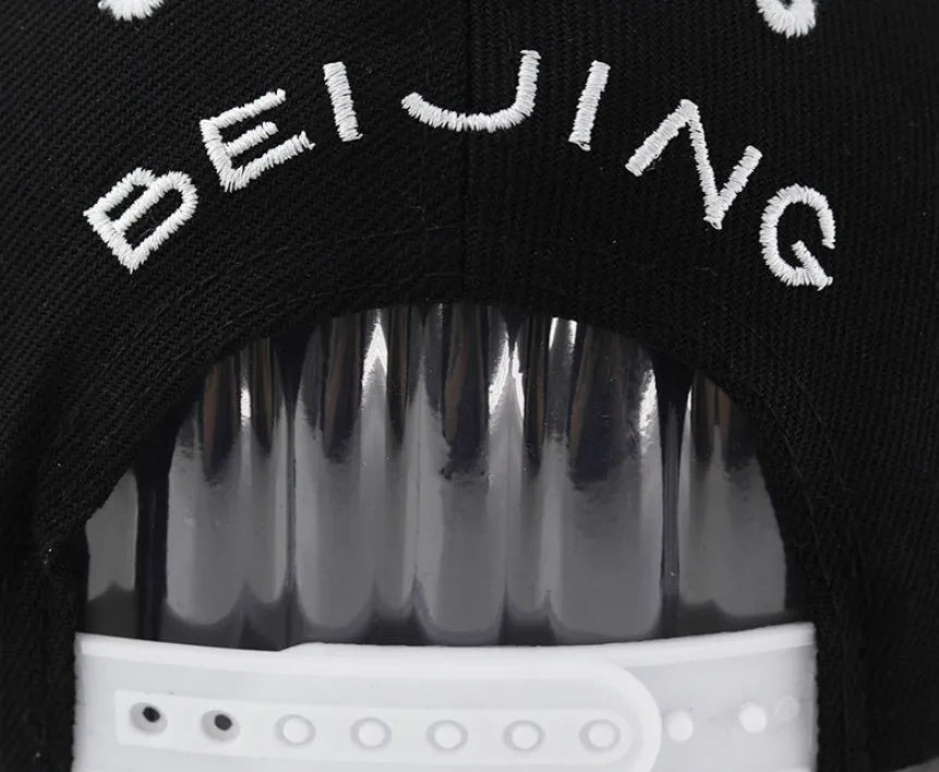 Cotton baseball cap with adjustable strap in black and white colour options