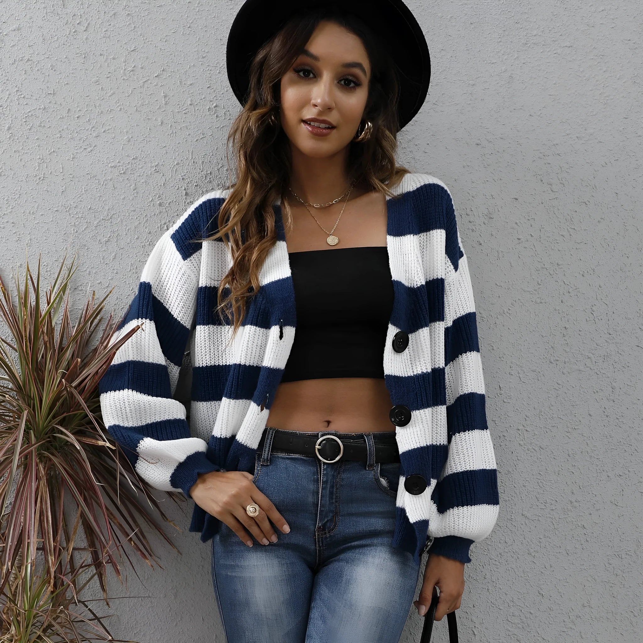 Women's striped cardigan sweater in deer plush polyester fabric on a hanger.