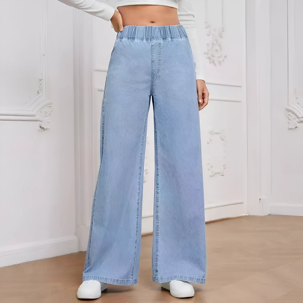 Light blue washed wide-leg straight-leg women's jeans on a hanger, showing mid-waist and zip fly detail.