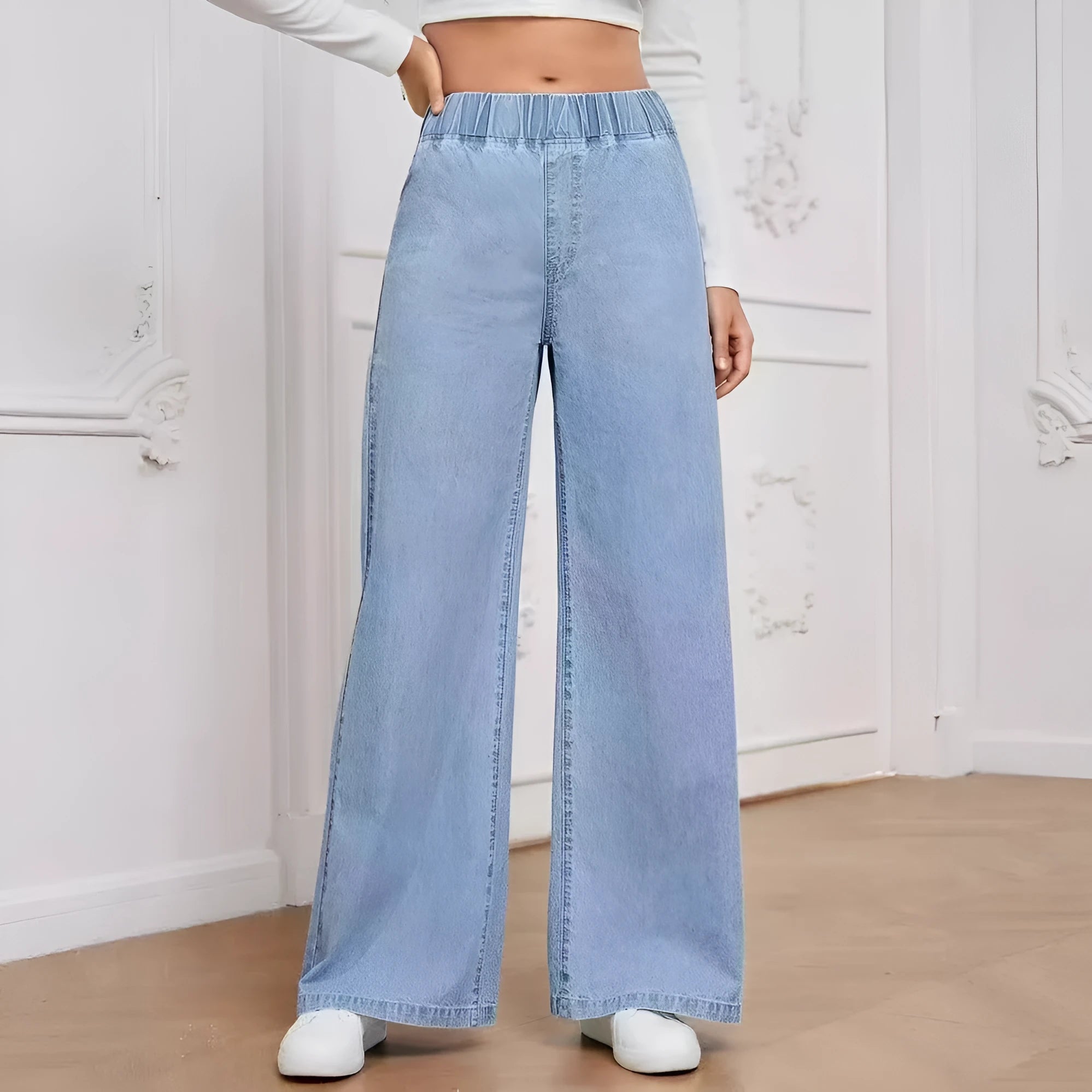 Light blue washed wide-leg straight-leg women's jeans on a hanger, showing mid-waist and zip fly detail.