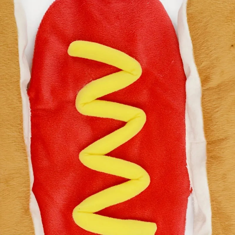 Small dog wearing a red and brown full-body hot dog costume with a bun-shaped hood.