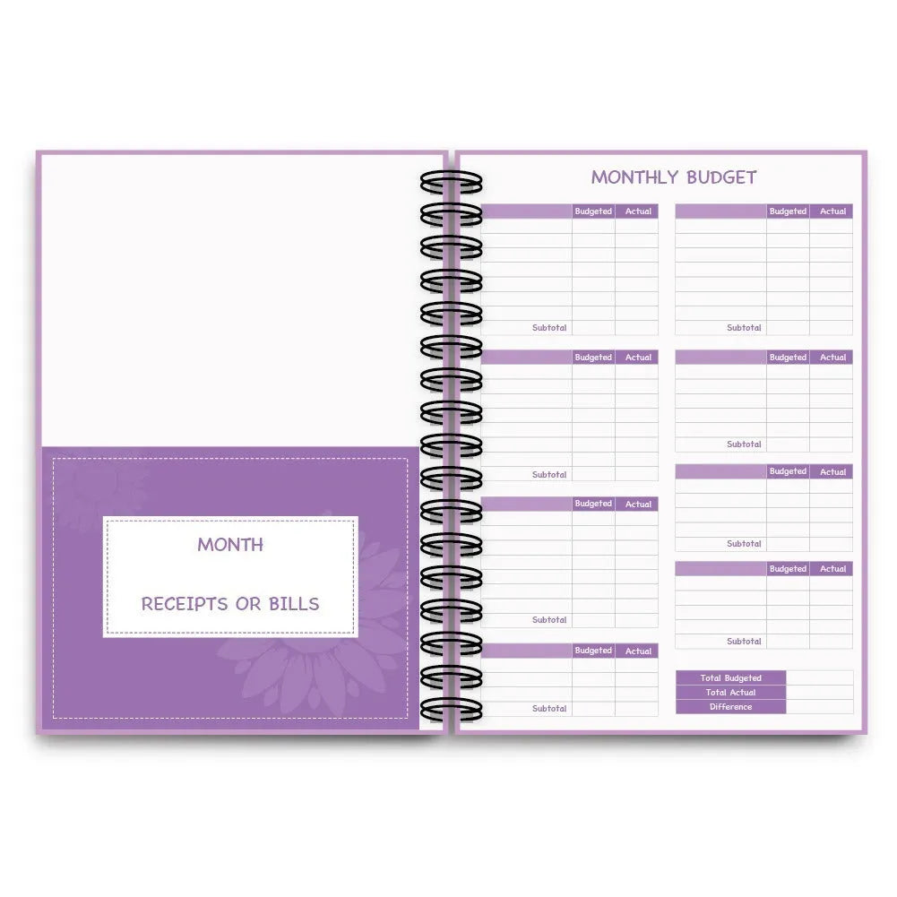 Purple coil-bound budget notebook with financial planning stickers and paper clips for monthly money management