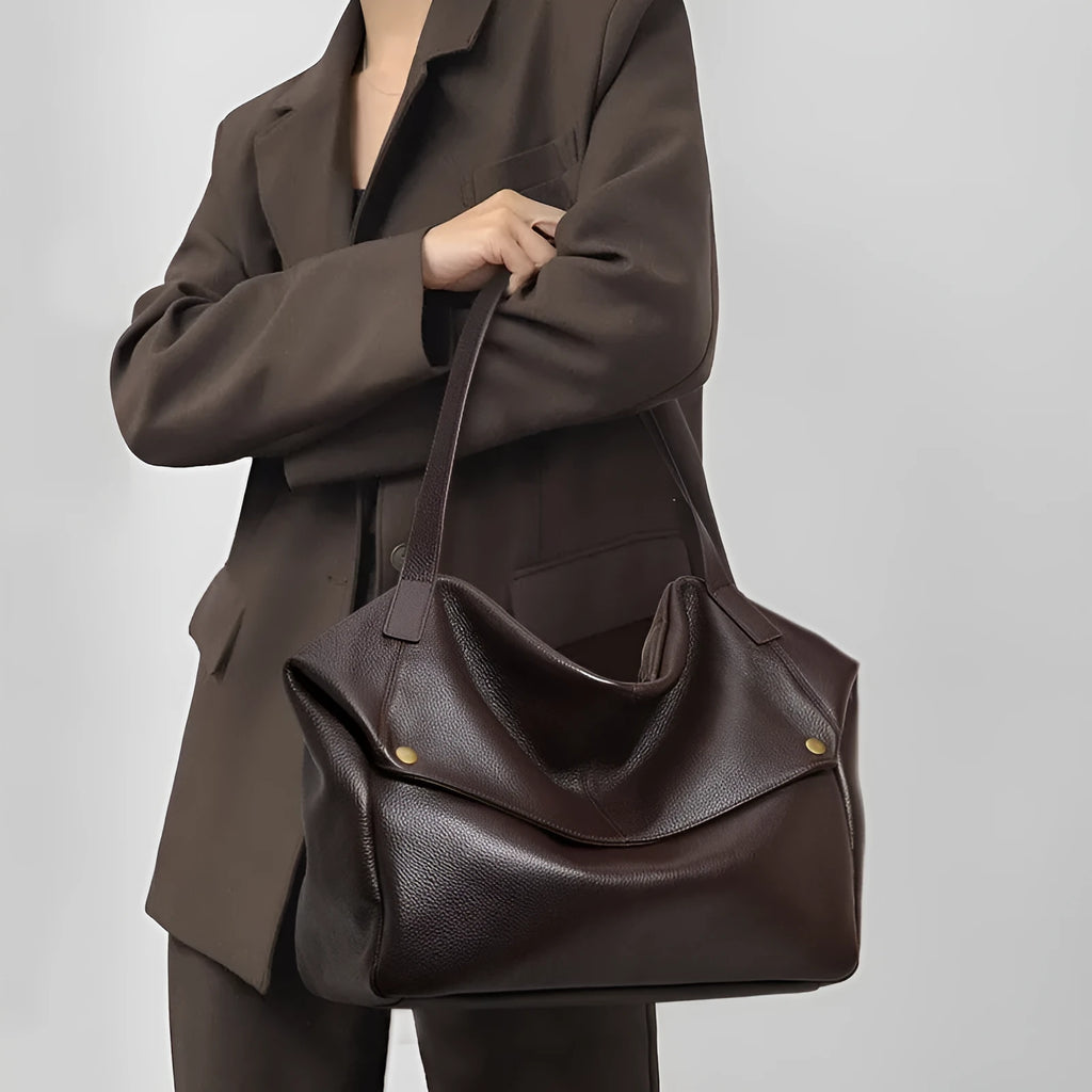 Brown genuine leather women's commuter shoulder bag showing horizontal square design and shoulder strap