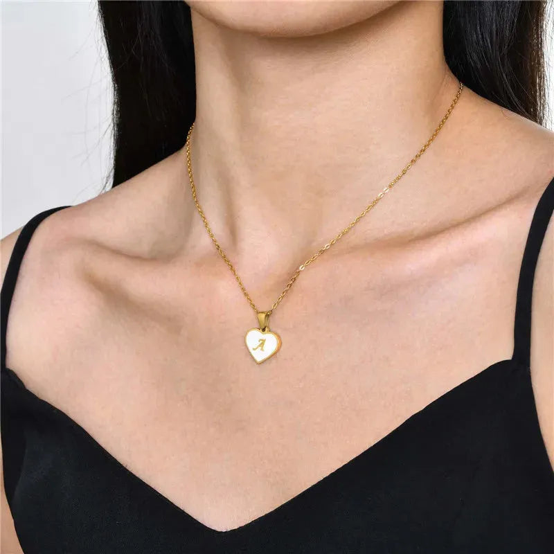 Gold heart necklace with white shell pendant and initial charm on 45cm adjustable chain
