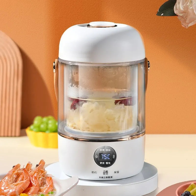 Personal portable electric stew cooker with transparent glass pot and fibreglass body on a counter.