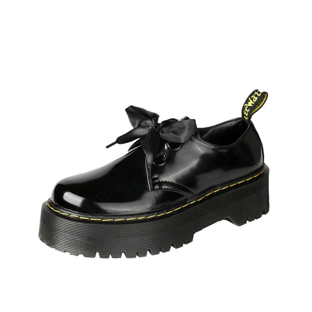 Women's thick soled leather shoes with cross straps and ribbons in black or white colours