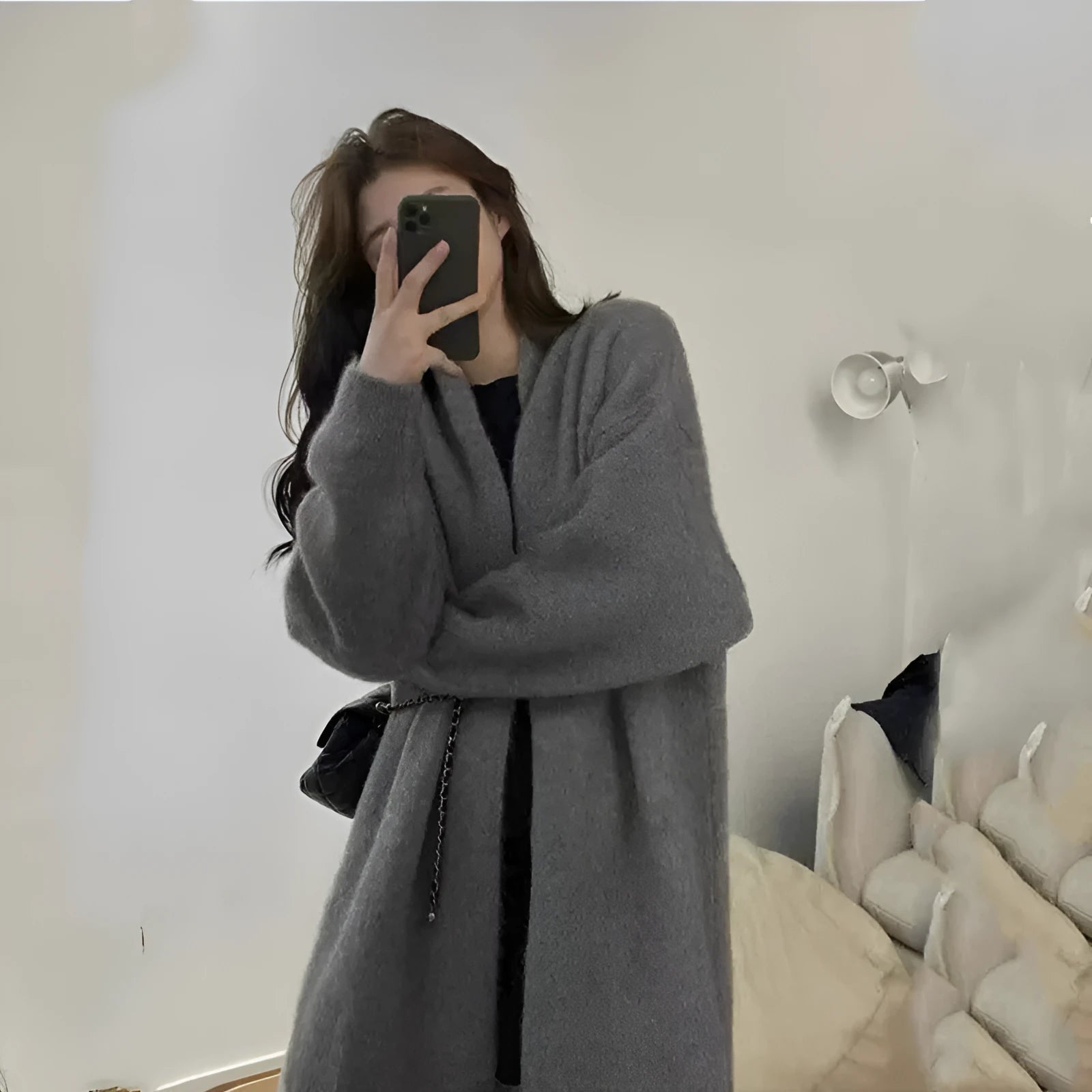 Loose large knitted women's cardigan in thick chenille fabric showing 3D pattern detail.