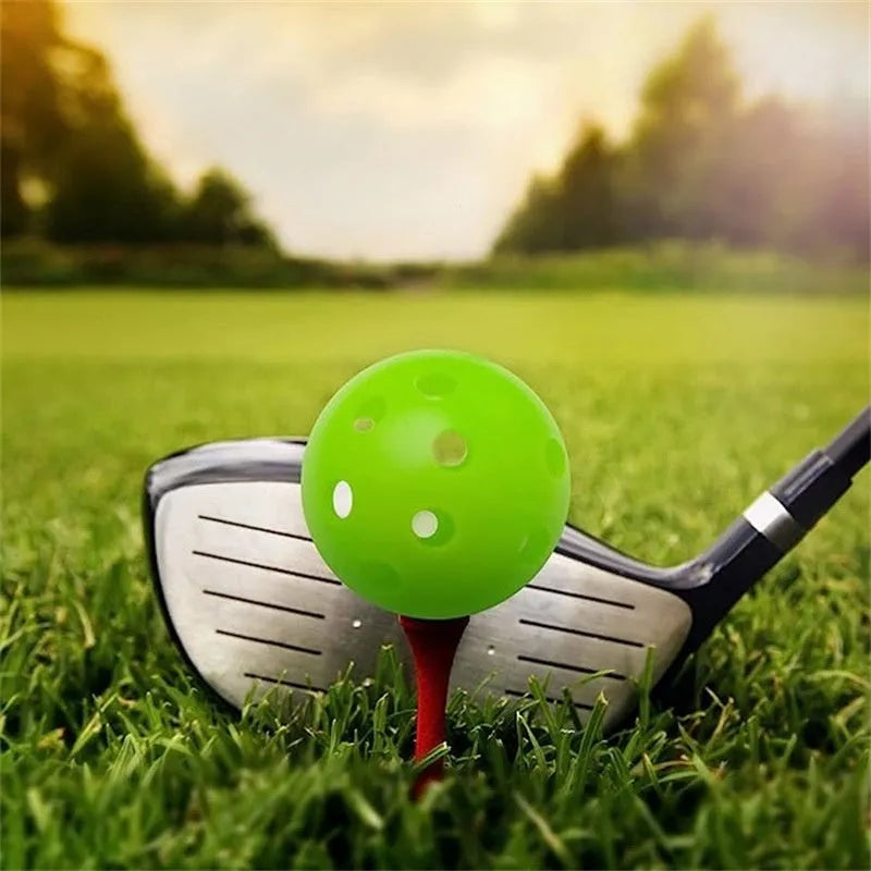 Multi-colour golf practice balls in net bag with 26-hole putting layout for skill development