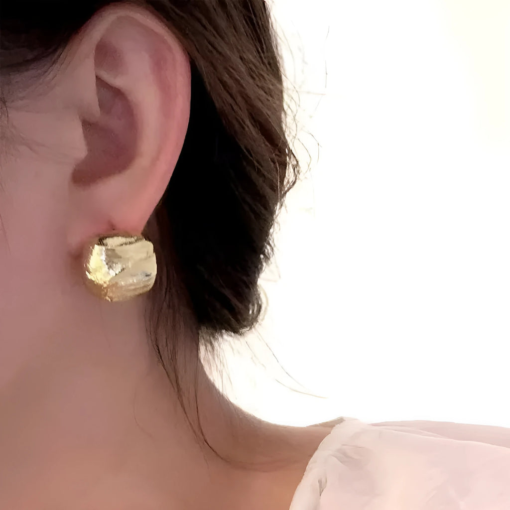Minimalist metal alloy stud earrings with a simple circle design on a white background.