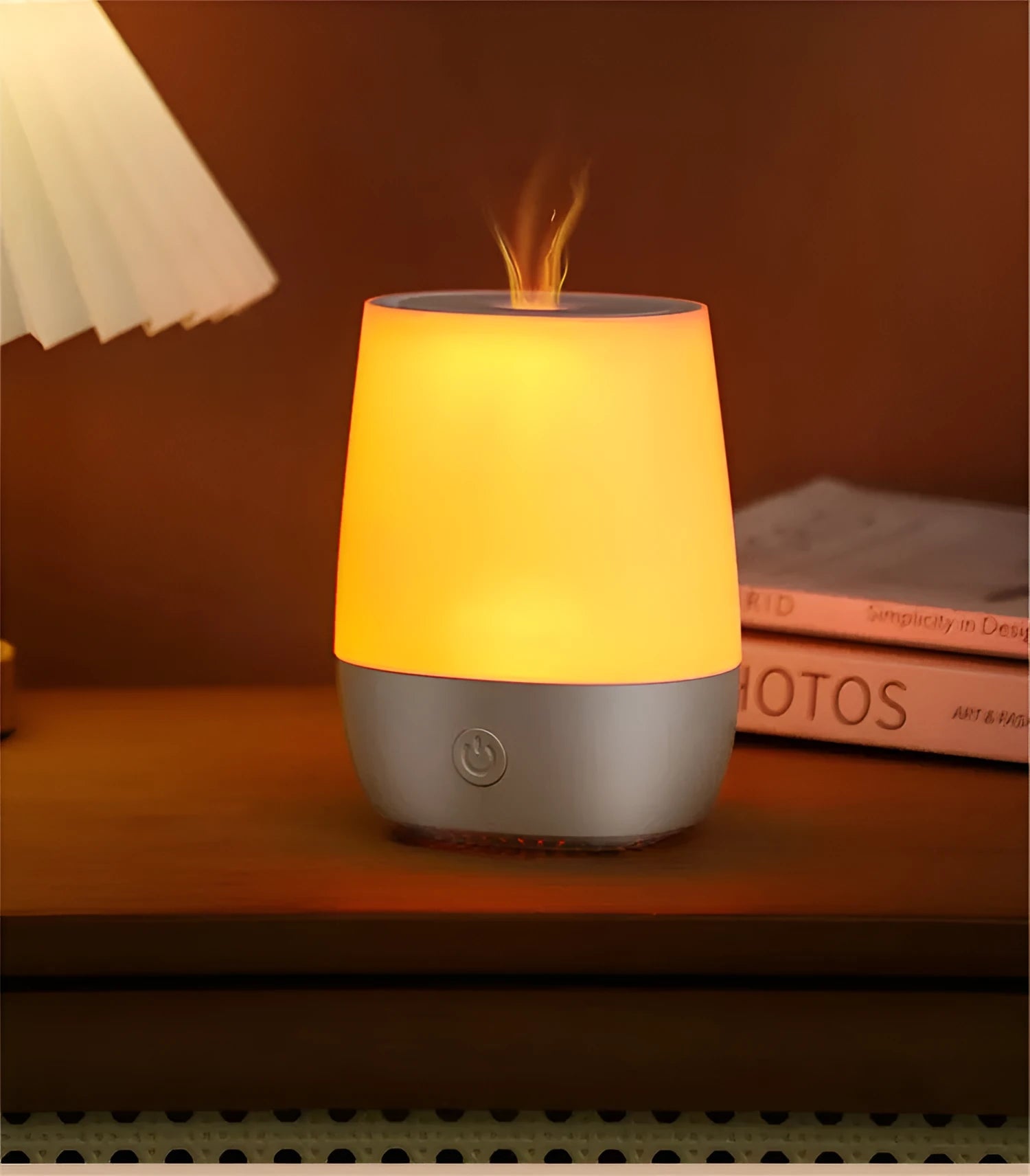 White USB aroma diffuser with simulated flame effect on a wooden surface.