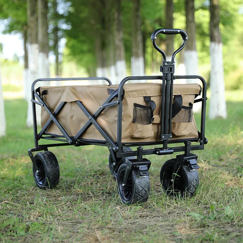 Folding camping trailer with four PU foam wheels and brake, 100KG capacity, in outdoor setting