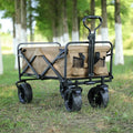 Folding camping trailer with four PU foam wheels and brake, 100KG capacity, in outdoor setting