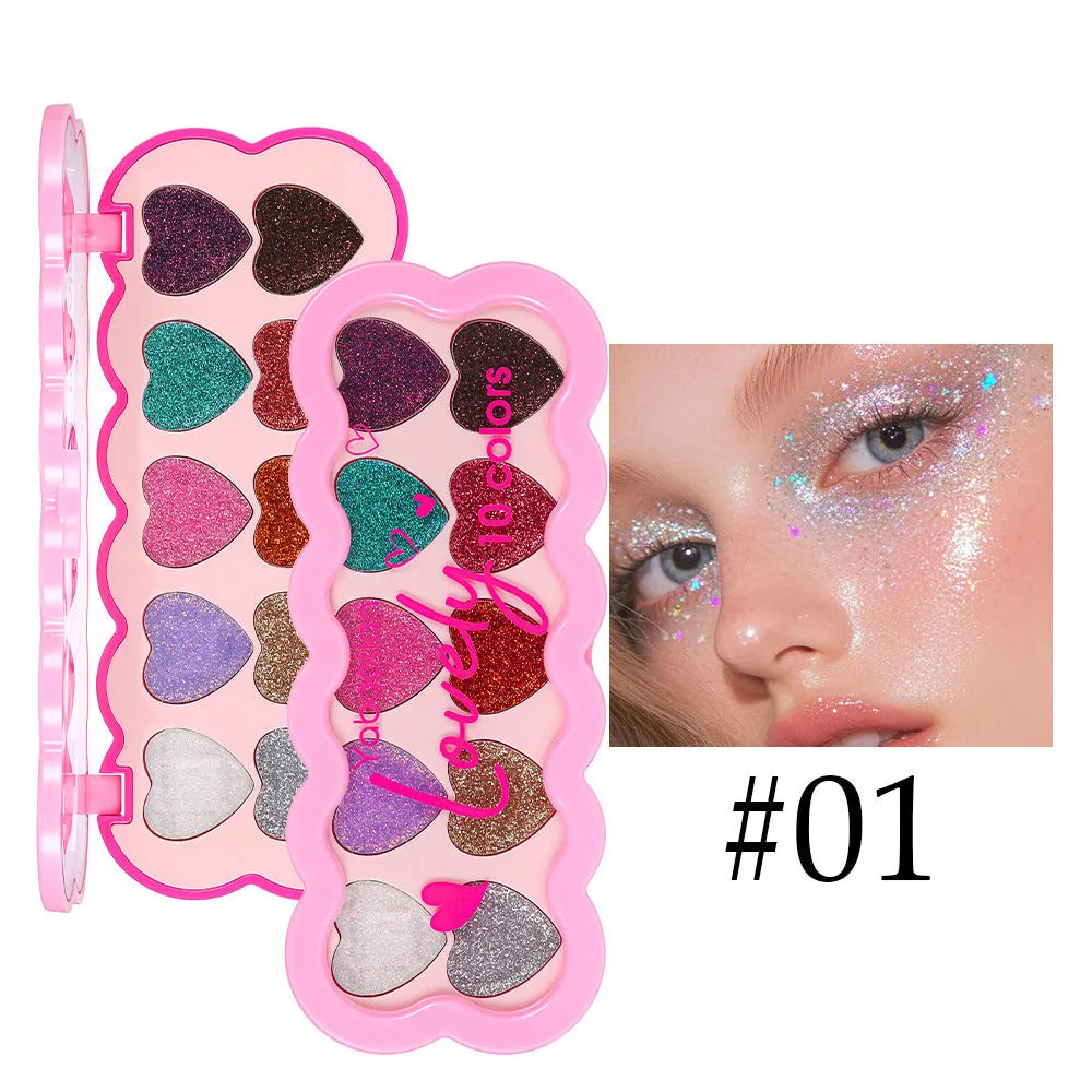Pearlescent heart design eye shadow palette showing ten colours including white, beige, pink, purple, brown, blue, black, royal blue, maroon, and coral