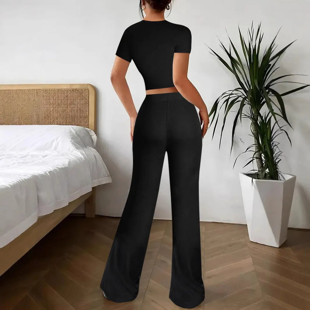 Black polyester women's high waist trousers and short sleeve t-shirt suit on hanger