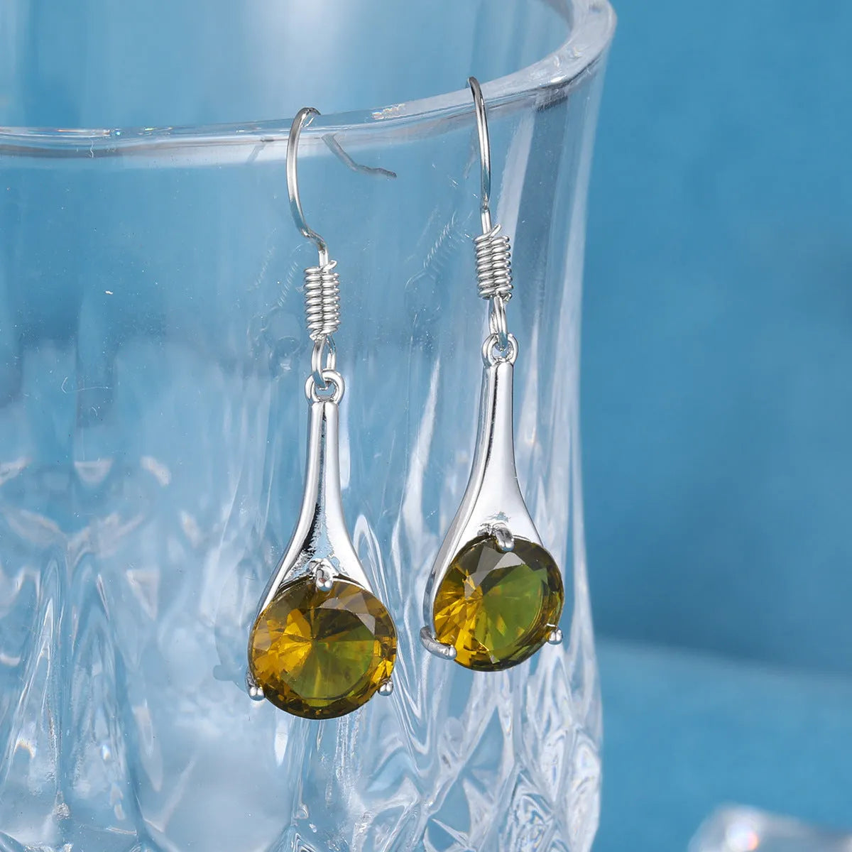 Olive green topaz drop earrings with water drop shape design and alloy construction