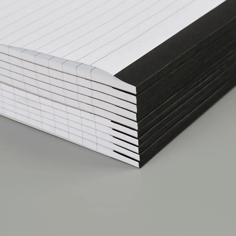 A4 tearable notebook with grid-lined ivory pages and a paper cover.