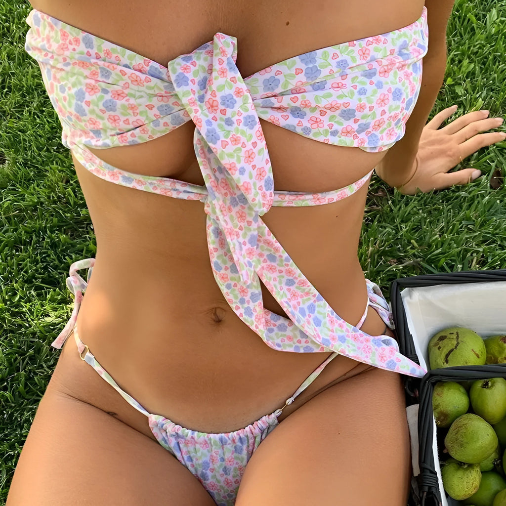 Women's lace-up front one-piece swimsuit with split-leg style in a floral print.