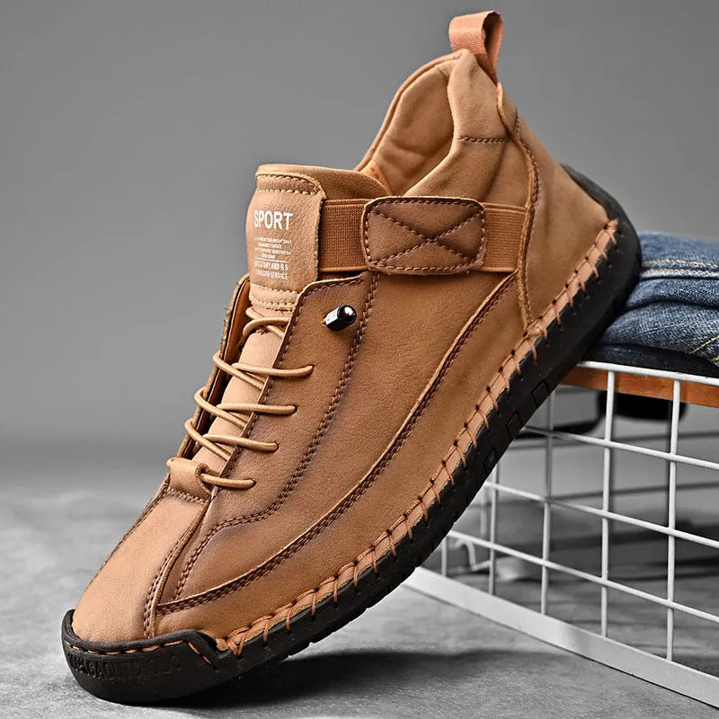 Men's mid-top casual boot in khaki with elastic band and tooling stitching detail.