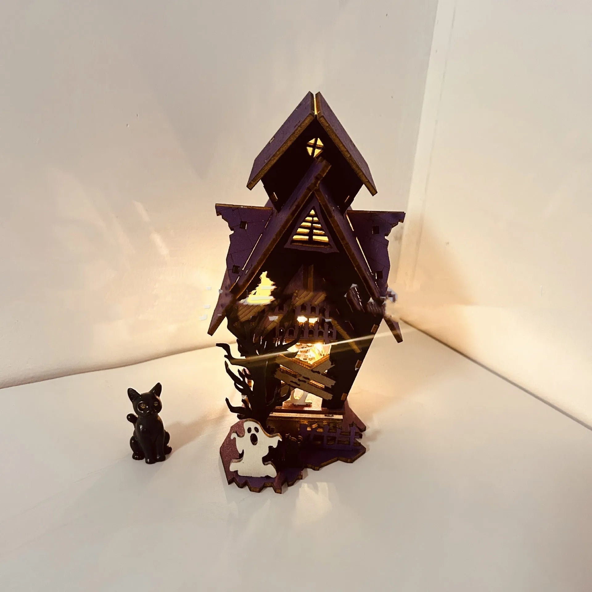 Wooden haunted house decoration with candlestick functionality measuring 14x10.5x19cm for Halloween table displays