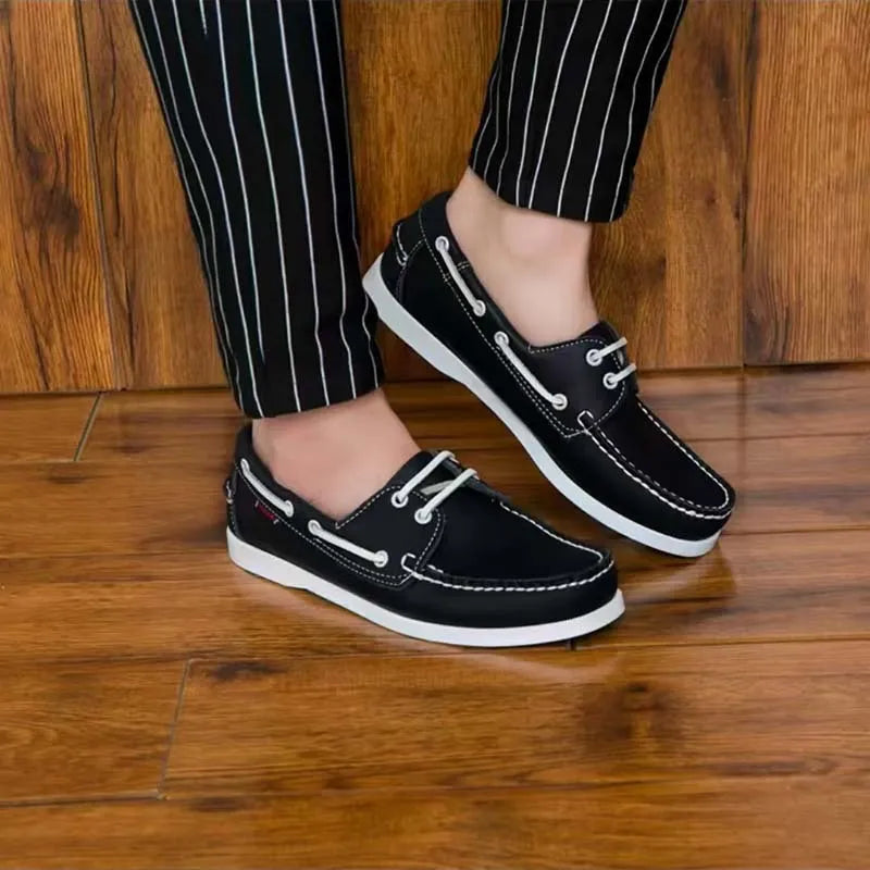 Men's black casual shoes with round toe, flat heel, and lace-up design on a white background.