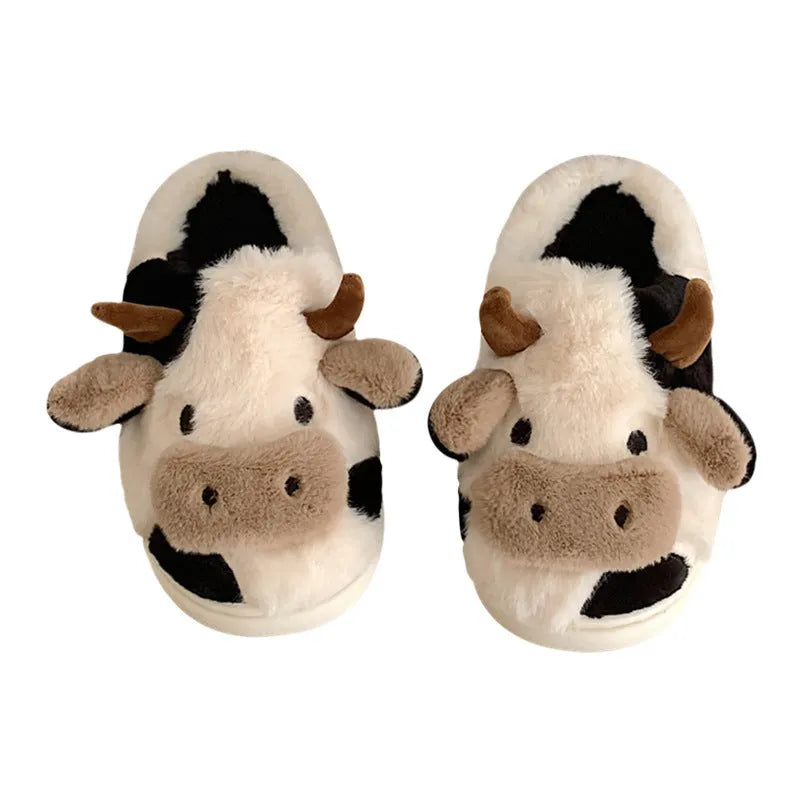 White cartoon cow plush slippers for women with a textured anti-slip sole.