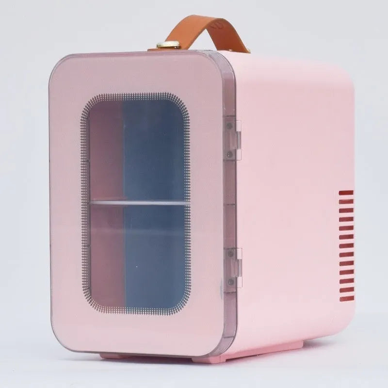 Pink mini refrigerator with transparent door showing interior storage for cosmetics