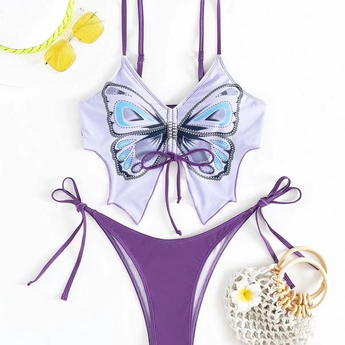 Women's purple bikini suit with bow ins style detail on a split design, made from polyester fabric.
