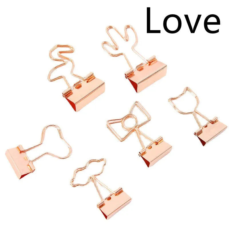 Gold-plated long tail hair clip showing decorative motifs including flamingo, love, clouds, cat, cactus, and bow designs