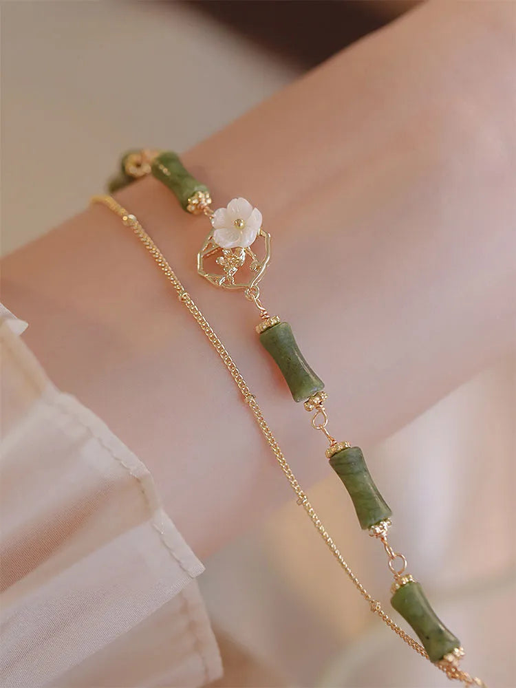 Natural green olivine bracelet with double layer design and Bells of Ireland charms