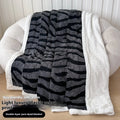 Double-layer cationic leopard jacquard taffeta blanket showing animal print pattern detail